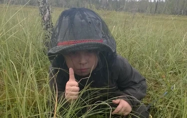 Angler catching a northern pike on a private river expedition in Molkojärvi, Lapland