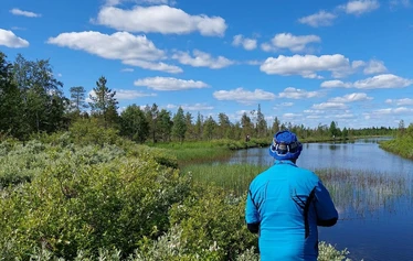 Angler catching a northern pike on a private river expedition in Molkojärvi, Lapland