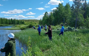 Angler catching a northern pike on a private river expedition in Molkojärvi, Lapland