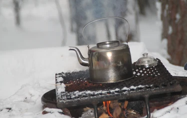 Grilling sausages beside the fire