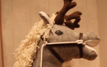 Riding a hobby horse in town of Porvoo during christmas market