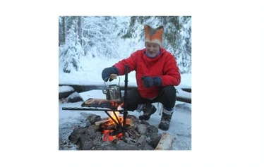 Grilling sausages beside the fire