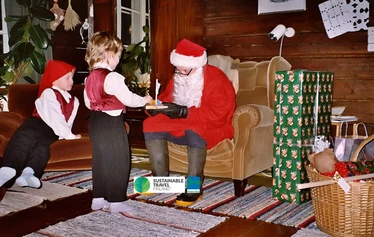Father Christmas gives presents to children