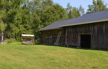 Das Hauptgebäude von Eskelänniemi. - Das Ferienhaus Eskelänniemi im Dorf Jyrkkä in Sonkajärvi, Nord-Savo, hat einen großen grasbewachsenen Hof.