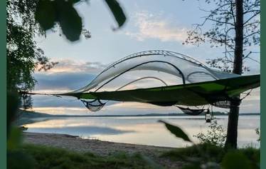 Vaarojen majojen puuteltat sijaitsevat Kiparinrannalla. - Puuteltasta on mahdollista ihailla järven taakse laskevaa auringonlaskua.